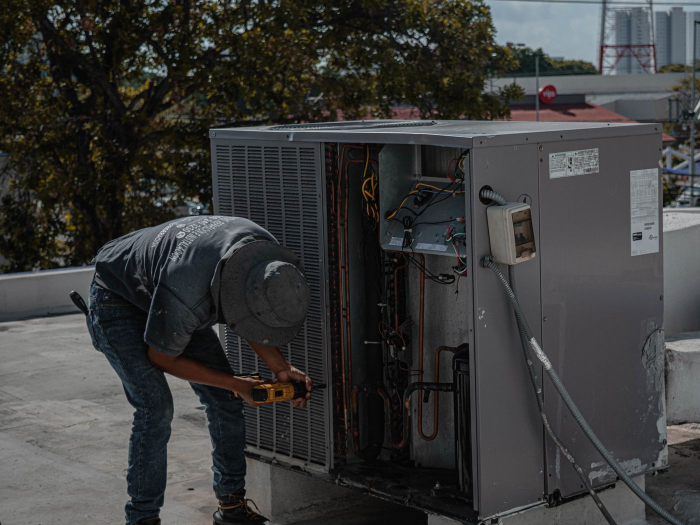 A technician servicing an air conditioning system