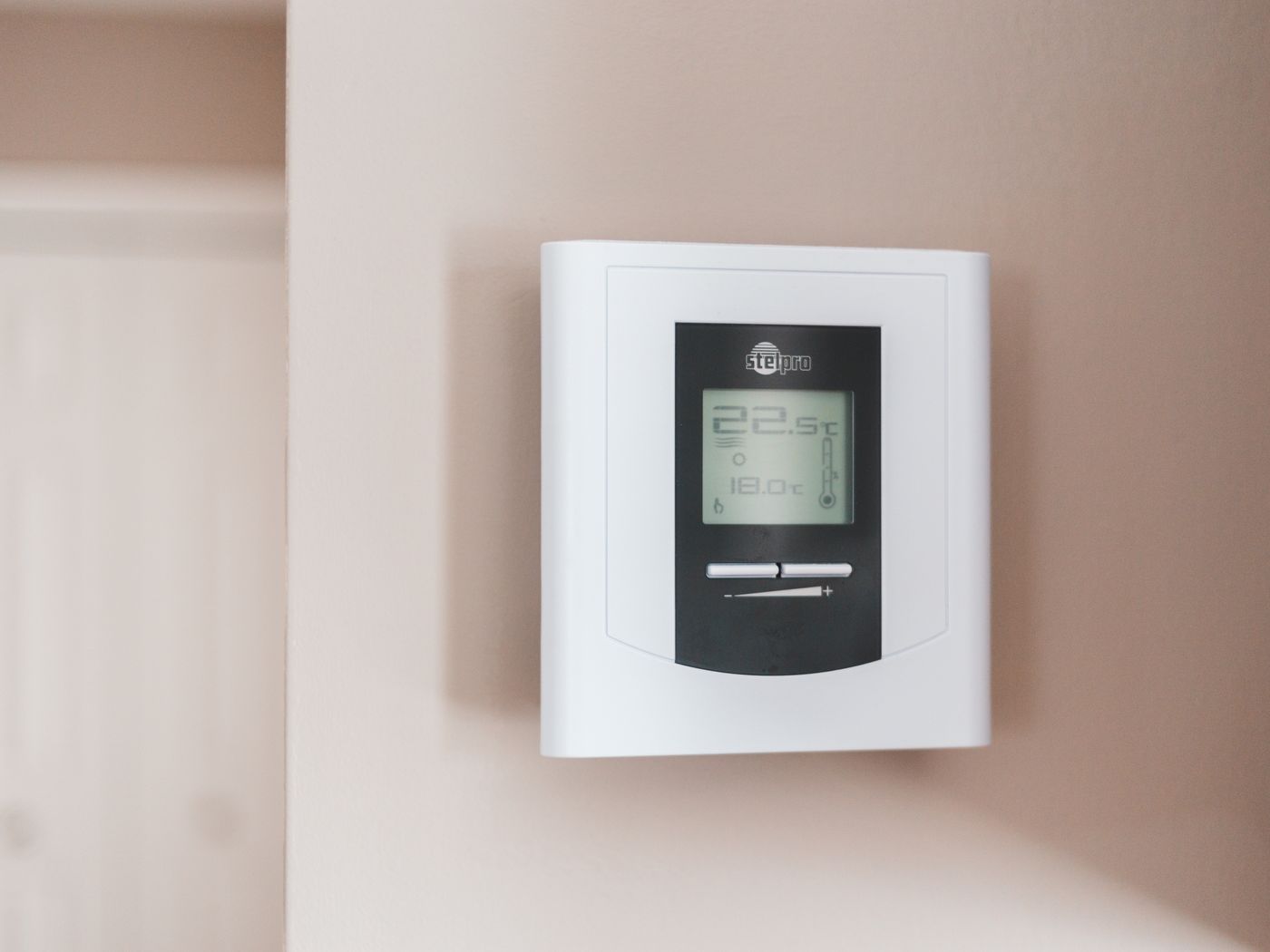 A smart thermostat on a wall