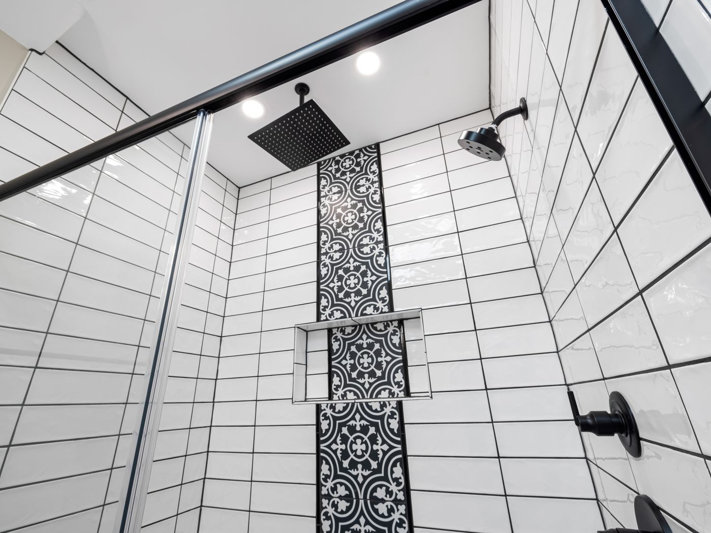 A renovated bathroom with tiled walk-in shower