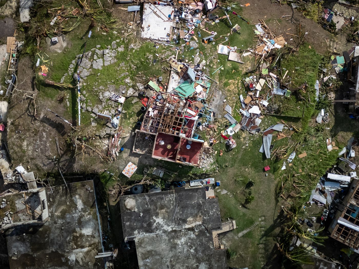 Storm damaged roof with displaced shingles