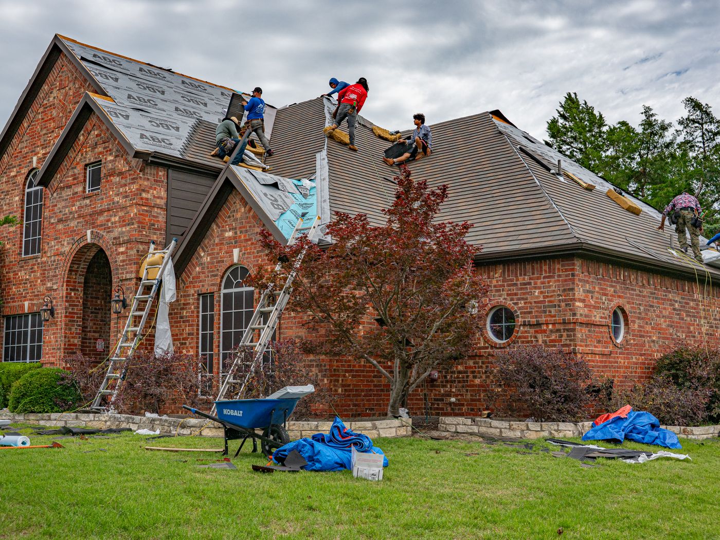 A roofing crew working on a residential roof