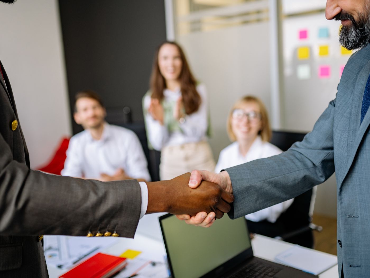 Two people shaking hands after a meeting
